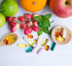 Multivitamin,supplements,from,fruit,on,white,wood,background,with,wooden